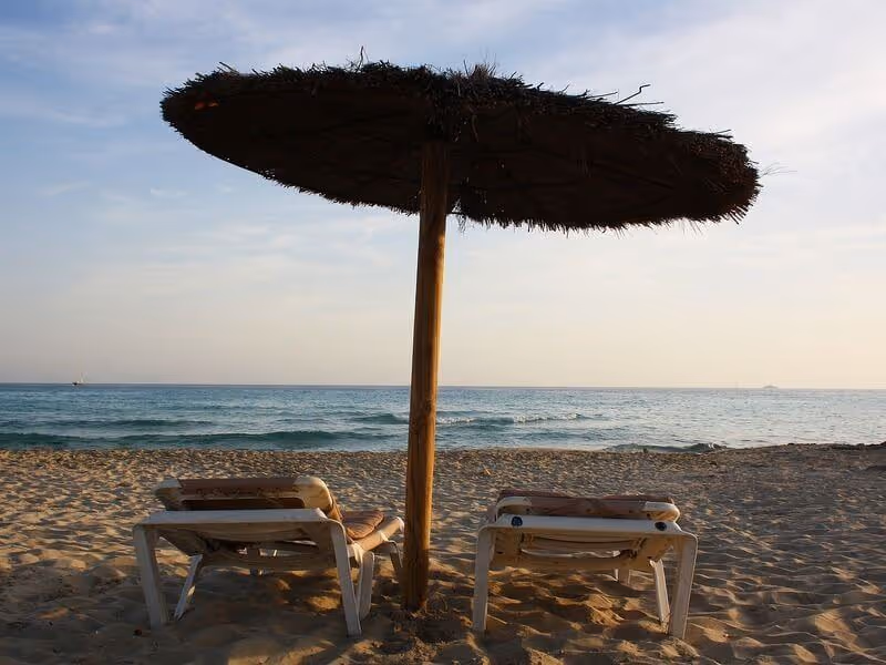 Parasol and sun loungers on Migjorn beach