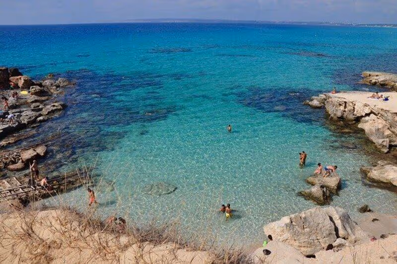 People swimming in a cove in Formentera