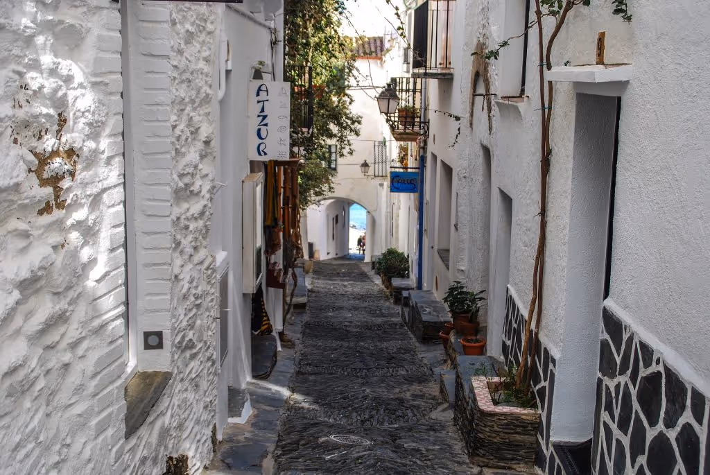 Narrow street with white houses in Cadaqués