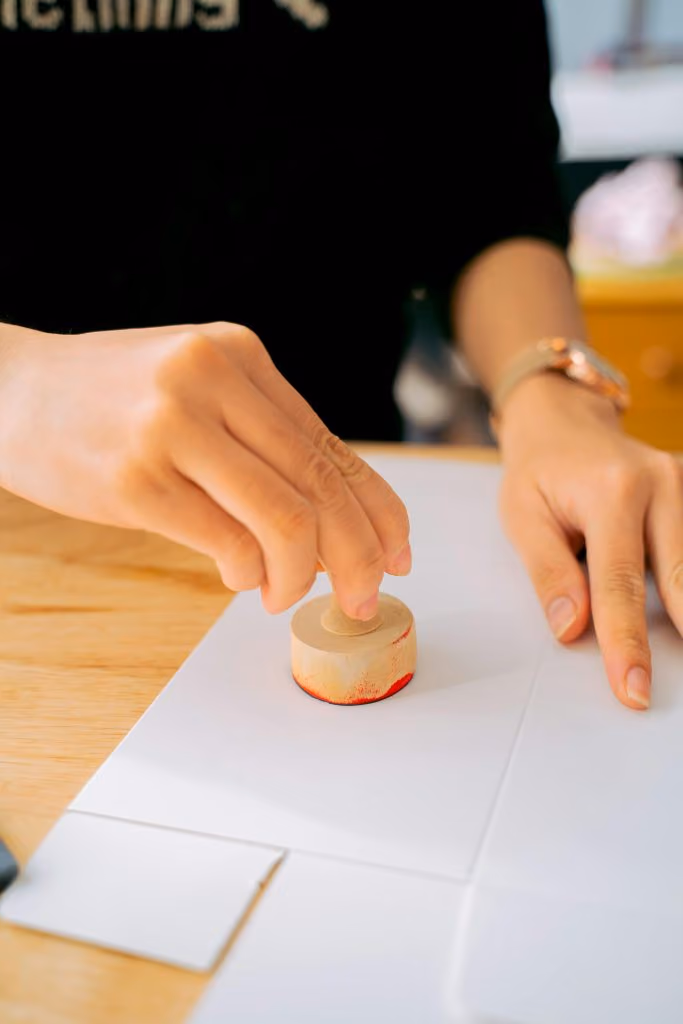 Signing a contract with a stamp, symbolising a buy-to-let investment in Spain in 2025.