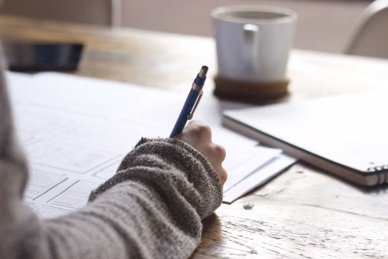 Person writing on a document