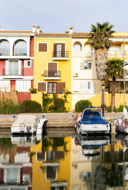 Colourful facades and boats moored in a marina in the Valencian Community